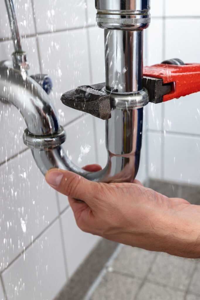 Plumber Repairing Sink Pipe Leakage